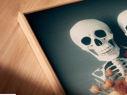 A close-up angled view of a canvas print in a floating frame. The artwork is a floral skeleton. This gothic macabre piece is perfect for adding a unique touch to your wall art collection. The floating frame enhances the artwork's visual appeal. It makes it ideal for dark academia and Halloween decor.