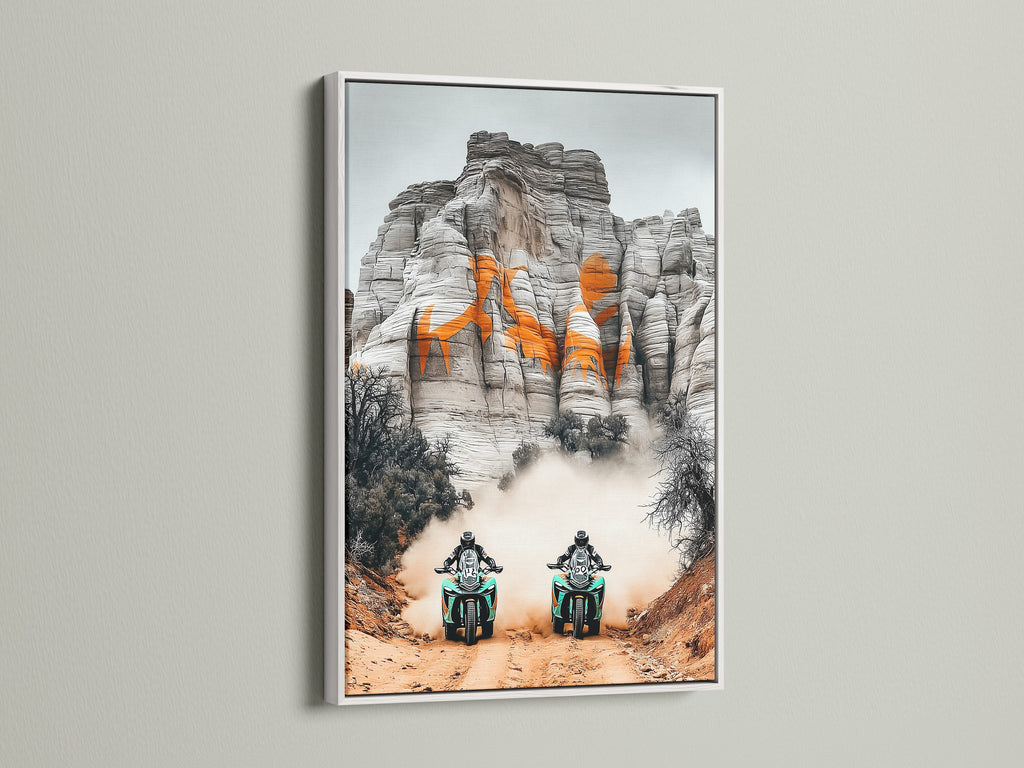 Add a touch of elegance with desert adventure art. This off road racing sports canvas print is displayed in a white frame. Perfect motorcycle wall art for man cave decor. Sports fans and business owners seeking adventure artwork will appreciate this piece. Elevate your space with this desert landscape motorcycle print.