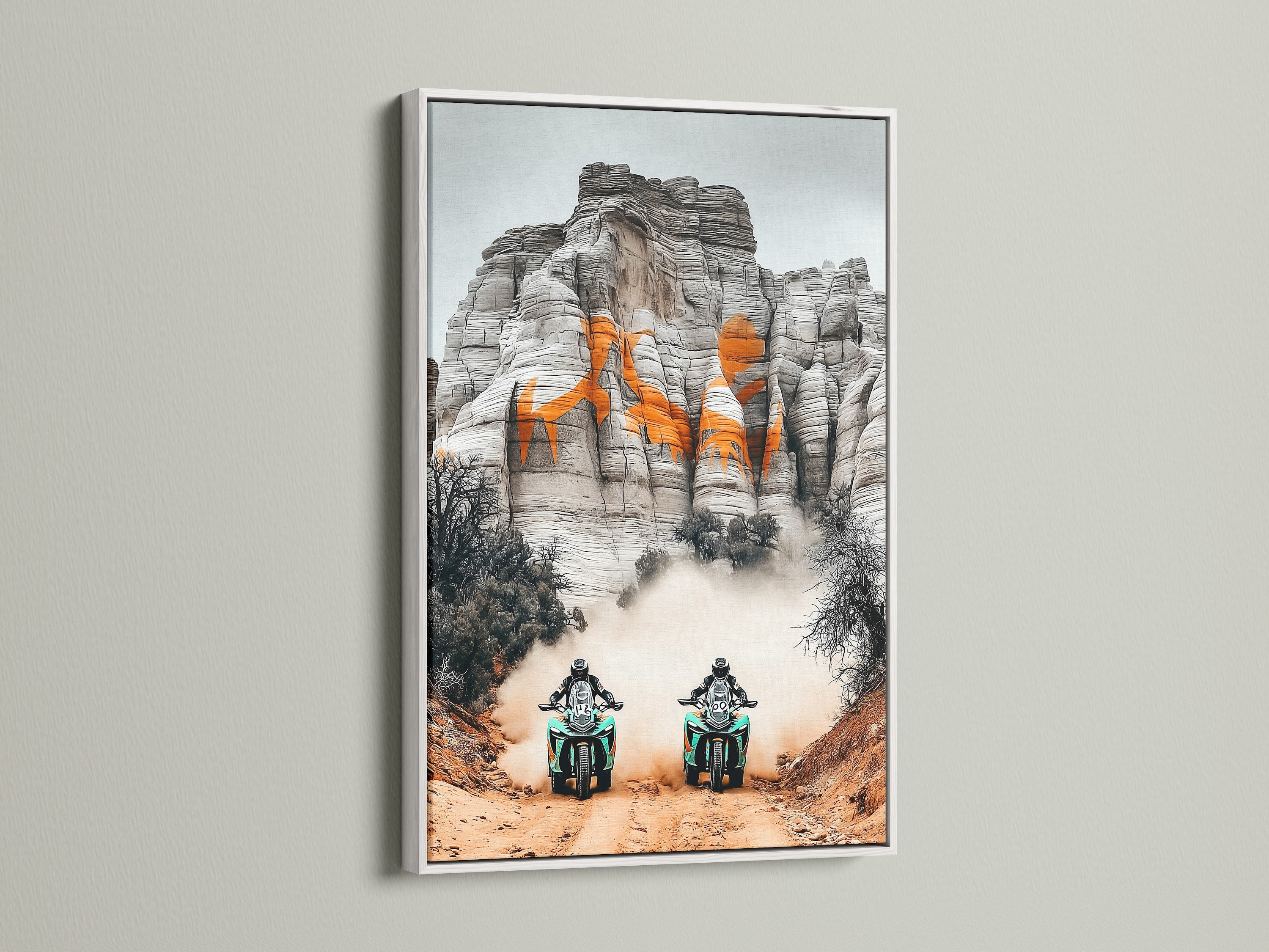 Add a touch of elegance with desert adventure art. This off road racing sports canvas print is displayed in a white frame. Perfect motorcycle wall art for man cave decor. Sports fans and business owners seeking adventure artwork will appreciate this piece. Elevate your space with this desert landscape motorcycle print.