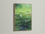An oak frame surrounds a beautiful piece of art. The artwork depicts a serene swan swimming in a pond. The art brings a sense of tranquility to any room. The oak frame enhances the artwork. It provides a natural and elegant touch.