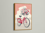 Vintage bicycle art print showcased in a gold frame. The coral pink floral bike artwork makes a statement. The botanical wall art brings nature indoors. Add a whimsical touch with this vintage bike poster. Perfect for eclectic or bohemian decor styles.