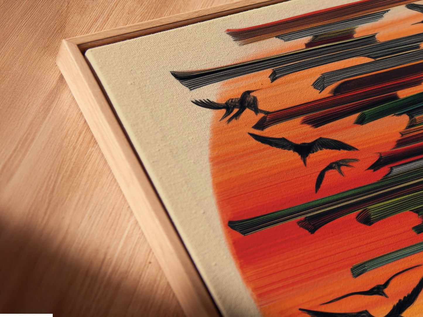 A close-up angled view reveals the Birds in Flight canvas print in a floating frame. The floating frame gives the abstract print depth. The modern artwork feels very high end. Perfect to complement minimalist decor.