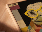 A close-up of the Turtle Scholar canvas print in a floating frame. The vintage animal art showcases quirky wall decor. The floating frame gives a modern touch. Perfect for study room art this animal portrait art is elevated. It is suitable for art deco or eclectic styles.
