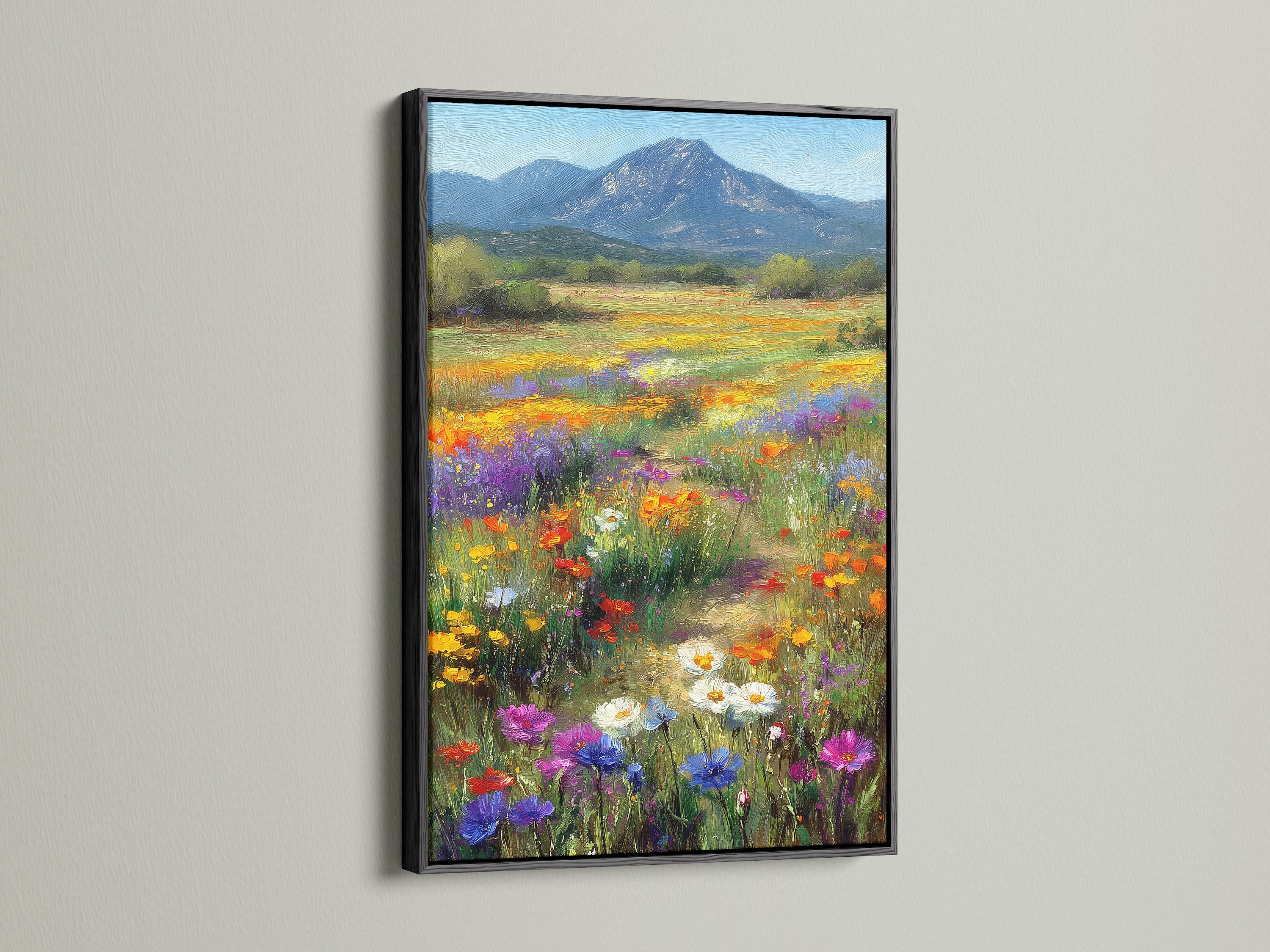 Wildflower meadow botanical artwork framed in black. This mountain landscape wall art offers a modern touch. The contrast enhances the colorful artwork. It's a striking piece for any room or office space.