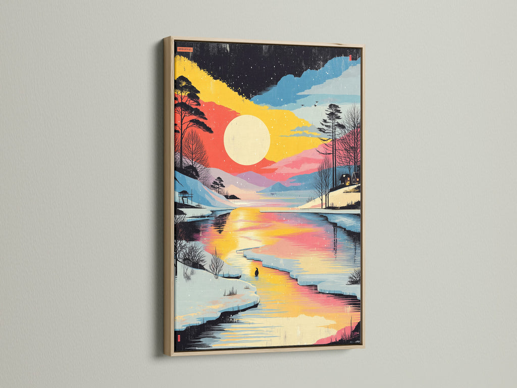 Winter Sunset Canvas Print in an oak frame. This artwork showcases a lake landscape. The snowy forest artwork provides a cozy feel. Ideal wall art for minimalist modern or cabin-inspired interiors.