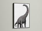 Dinosaur wall art featuring a minimalist brontosaurus canvas print. It is perfect modern nursery decor for a kids room. The artwork has a black frame. It is ideal for boys room decor and playroom artwork.