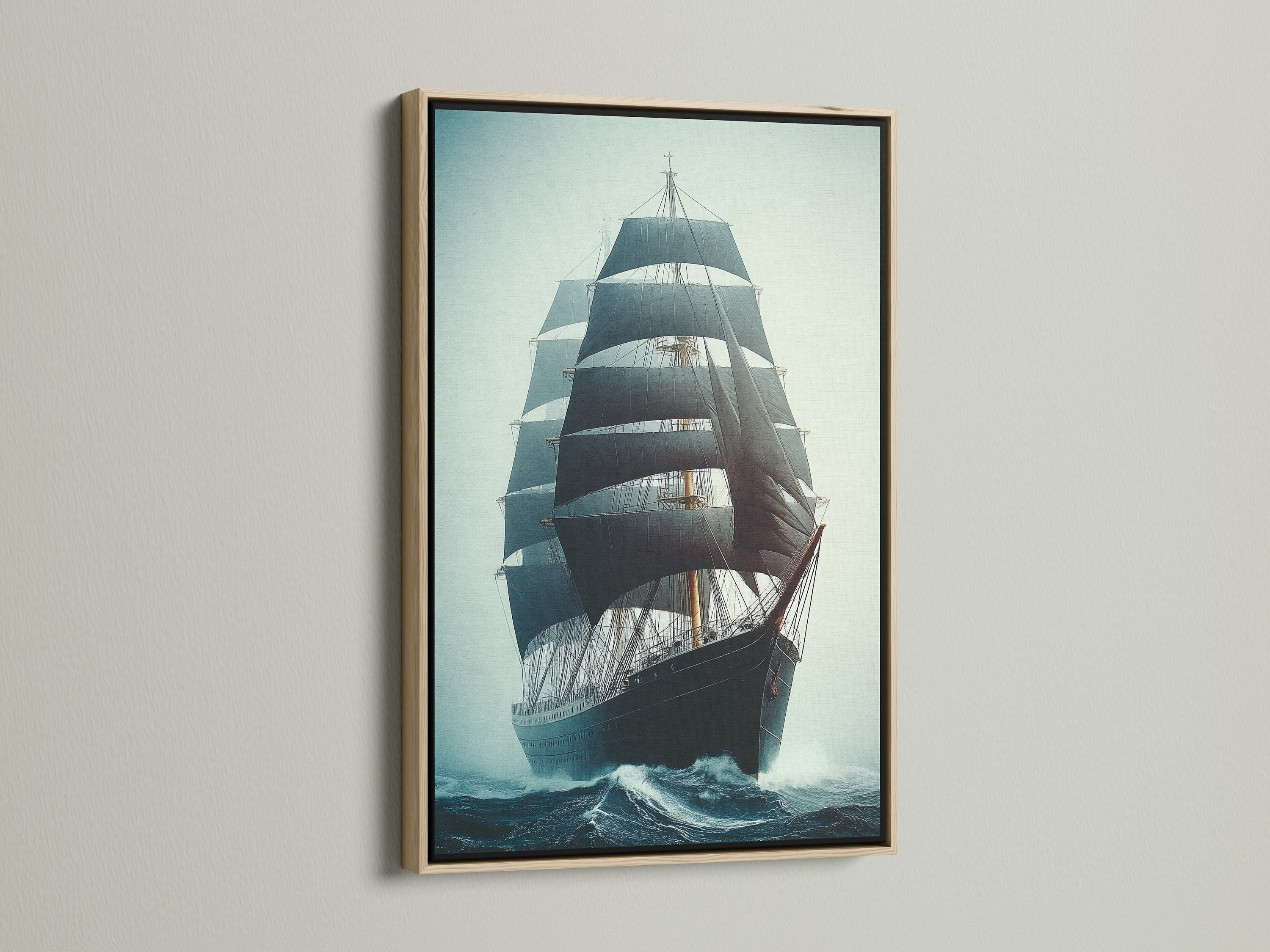 Sailing Ship Canvas Print in an oak frame. The artwork is a tall ship at sea. This nautical art adds a vintage touch to any room. The print brings a navy blue decor element.
