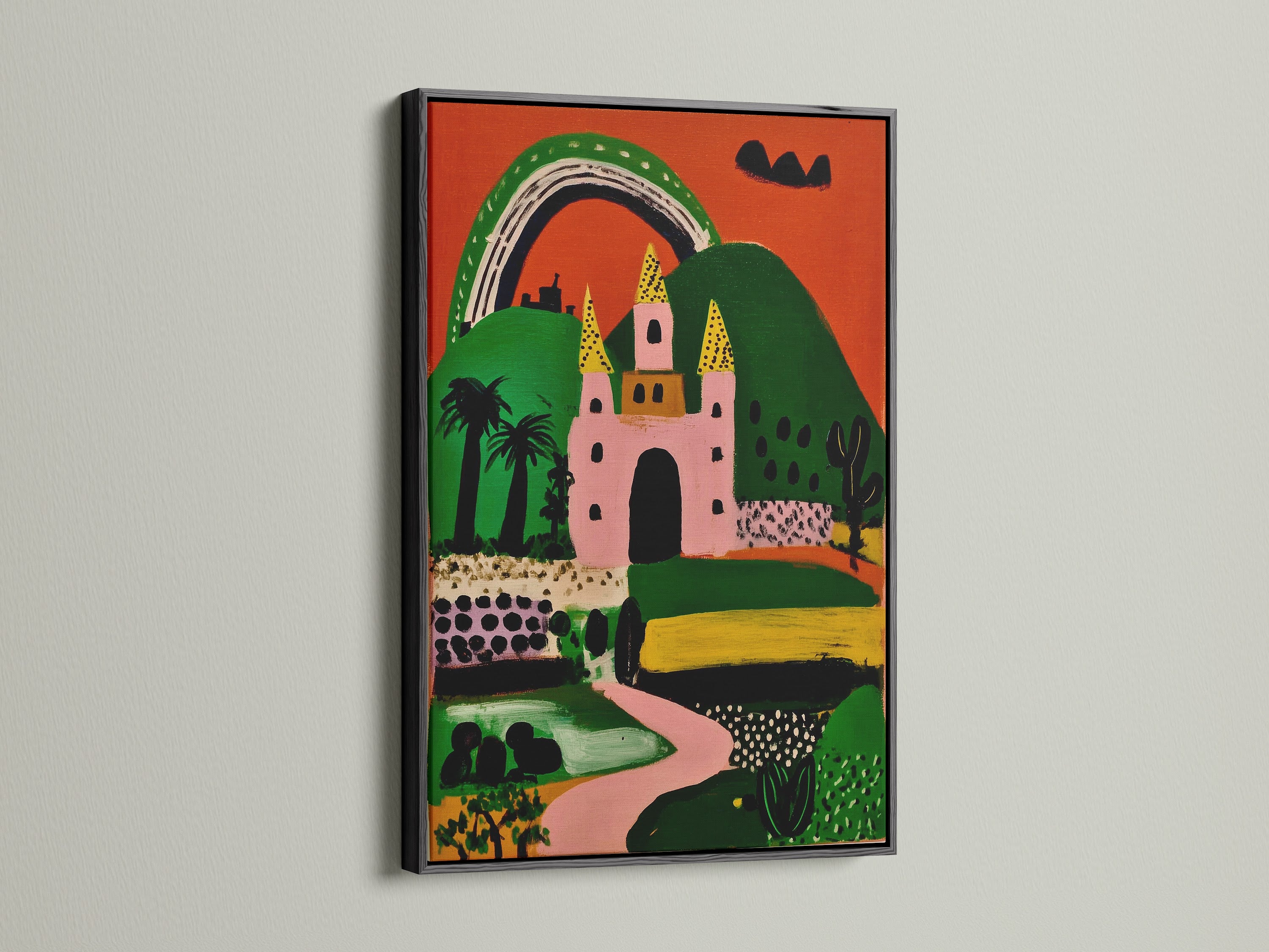 The whimsical fantasy castle artwork is framed in black. The print shows a pink castle green hills and a bright rainbow. A playful art piece perfect for kids wall art. It adds a unique touch to any space.
