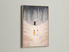 The oak frame enhances the winter landscape artwork. Figures are seen in a snowy field. This minimalist piece suits farmhouse and modern styles. Perfect wall decor for a cozy atmosphere.