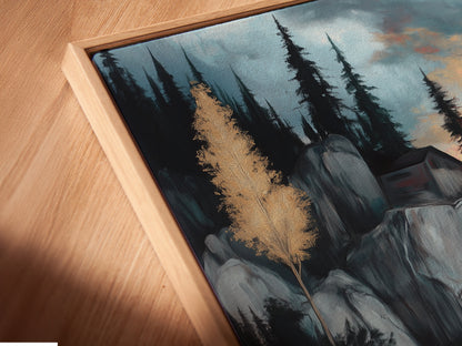 A close-up angled view of a Lakeside Cliff canvas print in a floating frame. A modern take on serene mountain artwork. Perfect for study room decor. This moody landscape features blue and gray tones. The tranquil scene shows a mountain painting and water reflection artfully combined.