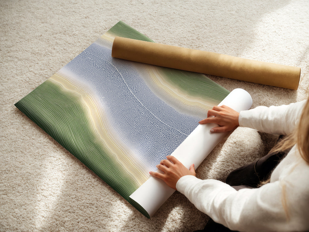 A woman is carefully rolling a fine art poster paper. This action preserves the quality of the abstract river artwork. The poster paper is ideal for creating affordable wall art. It is perfect for adding calming artwork to your space.