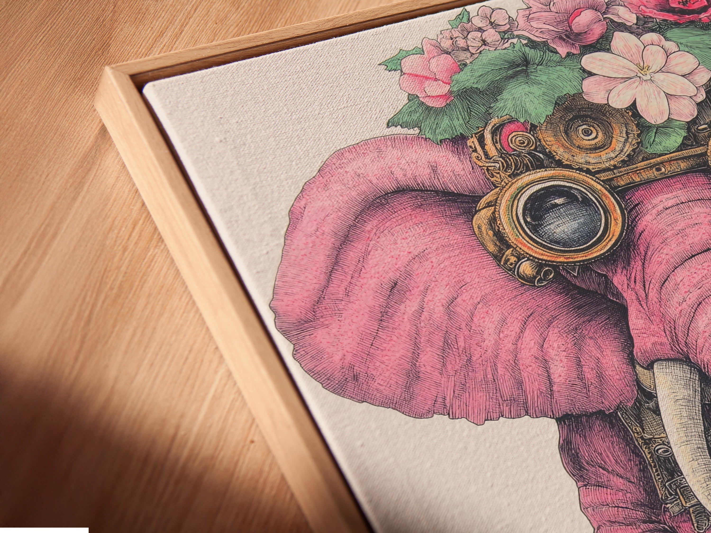 A close-up shot highlights a canvas print of a steampunk elephant in a floating frame. The pink elephant artwork features flowers and steampunk goggles. The floating frame adds depth enhancing its bohemian style.