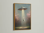 A gold frame surrounds the UFO Cat art print. The gold frame complements the pink and green tones. This space art print brings cosmic charm to your home or office.