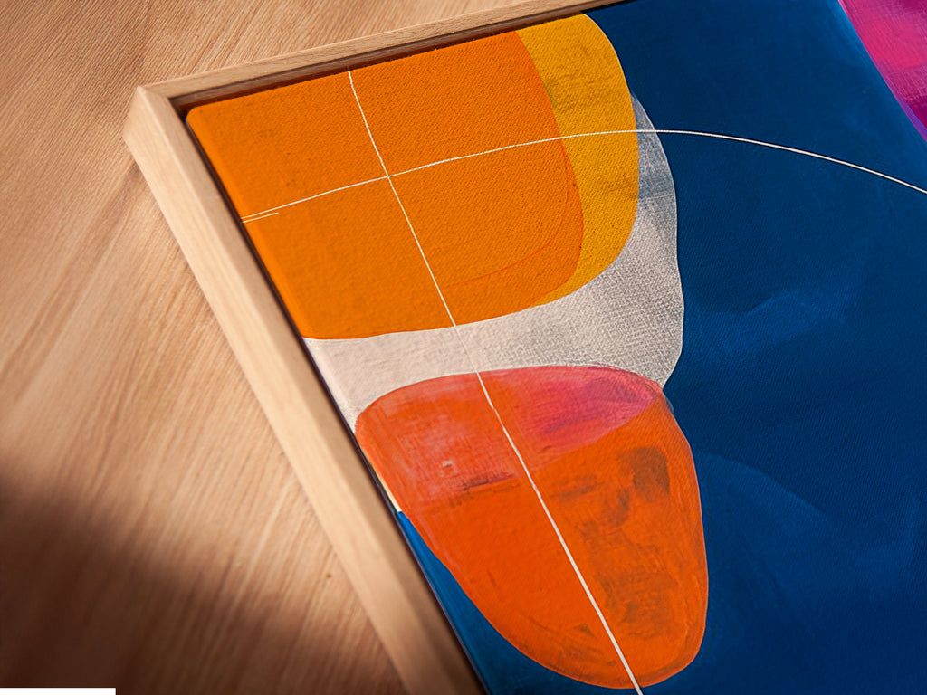 Close-up of a Canvas Print in a Floating Frame. The abstract geometric artwork features a navy blue background with colorful shapes. This modern canvas art adds a sophisticated touch to any room. Perfect for those seeking unique wall art solutions