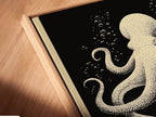 Angled close up of a canvas print in floating frame. The octopus canvas print is nautical wall art. This piece shows coral reef art for coastal home decor. The floating frame gives a gallery look to this ocean creature artwork.