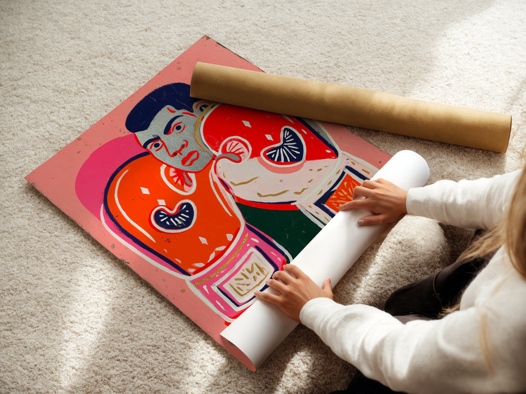A woman carefully rolling a fine art poster paper of the boxing legend artwork. The retro pop art style is vibrant. This poster is perfect for framing. It will bring athletic inspiration to any space. Consider it for sports art.
