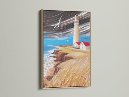 A serene lighthouse art print framed in oak. Coastal wall art brings a nautical touch. The seascape painting enhances any beach house decor. Ocean view art at its finest.