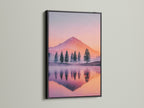 A mountain lake artwork is presented with a black frame. The black frame adds a modern edge to the pastel sunset wall art. This nature print captures a serene tree reflection. It is perfect as wilderness art or landscape decor. Elevate your space with this striking mountain decor.