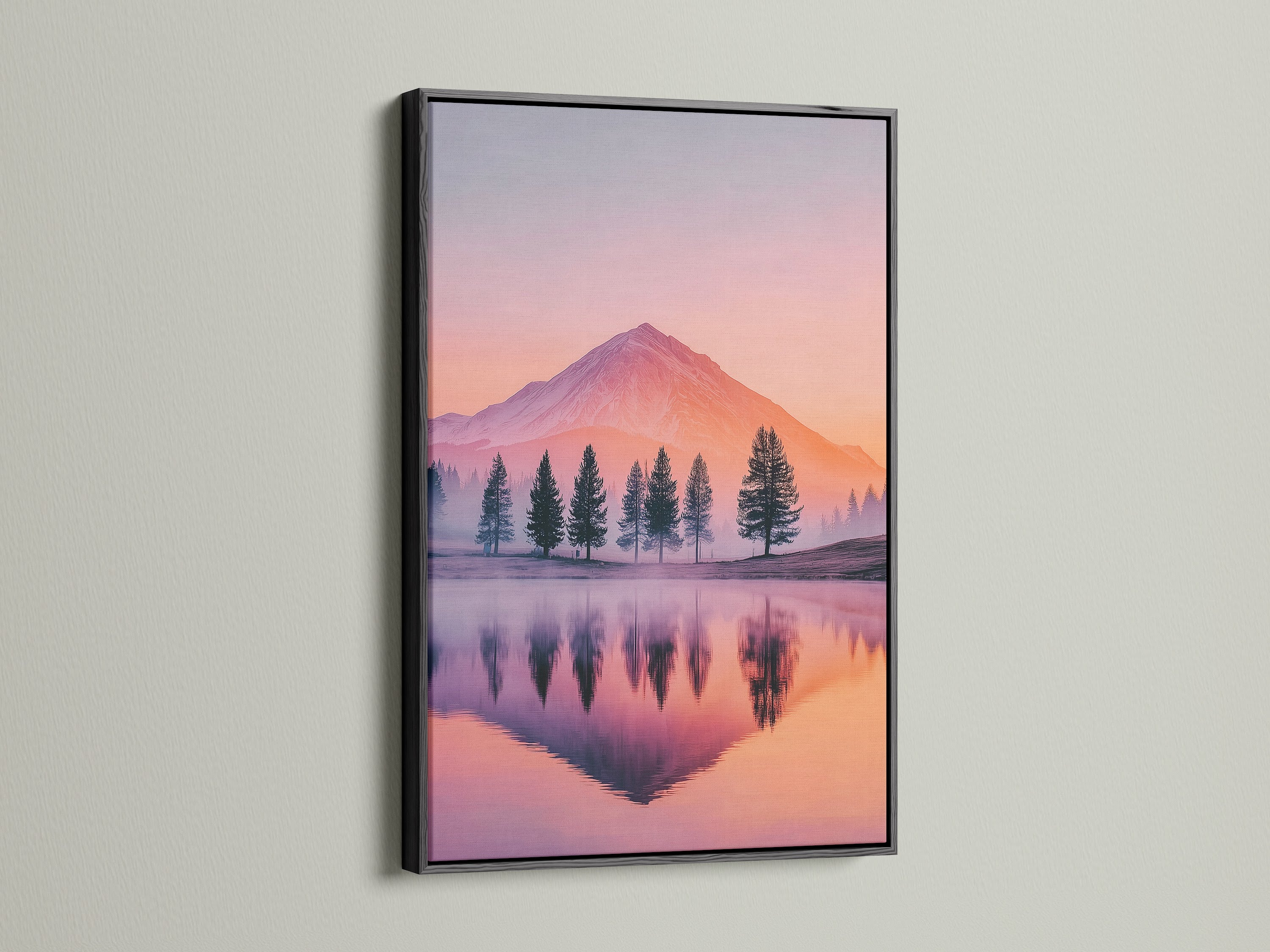 A mountain lake artwork is presented with a black frame. The black frame adds a modern edge to the pastel sunset wall art. This nature print captures a serene tree reflection. It is perfect as wilderness art or landscape decor. Elevate your space with this striking mountain decor.
