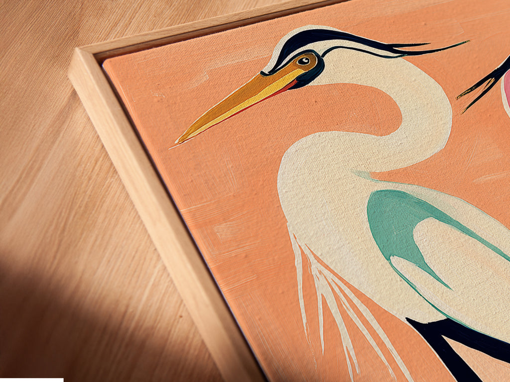 An angled close-up showcases a canvas print of heron artwork in a floating frame. The floating frame gives the illusion that the artwork is suspended. This artwork is perfect for coastal minimalist or contemporary styles. The heron art adds a touch of nature to any room. It is perfect for homeowners renters and interior designers.