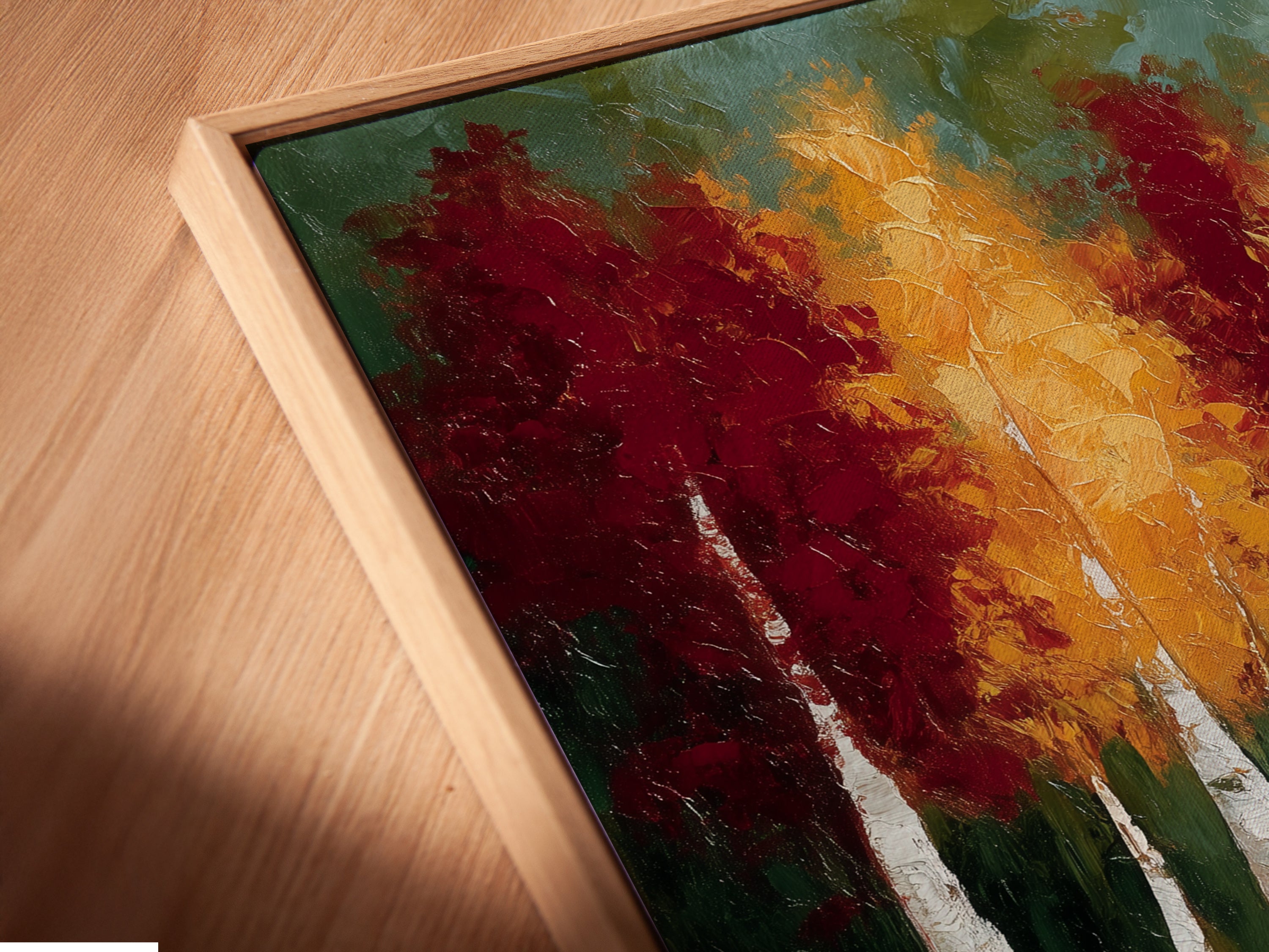 Close-up of a canvas print in a floating frame. The autumn trees artwork features a reflected landscape and teal blue lake. The floating frame adds a modern touch. Perfect wall art for minimalist coastal and rustic decor styles.