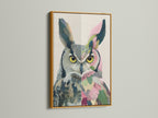 The colorful owl artwork is displayed in a luxurious gold frame. This whimsical animal art adds elegance to your walls. The gold frame complements the artwork's botanical details. A great gift.