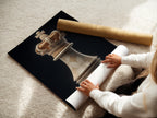 A woman is carefully rolling a fine art poster paper. She ensures its pristine condition. The poster paper is of high quality. It preserves the integrity and beauty of the artwork for future display.