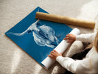 A woman is carefully rolling a fine art poster paper. This showcases the delicate handling of the longhorn bull artwork. The fine art poster paper ensures high quality prints. Perfect for art collectors and enthusiasts.