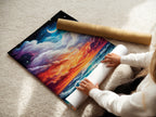 A woman carefully rolling a fine art poster paper of a coastal artwork. The ocean sunset art is printed on high-quality material. Ensuring a stunning and long-lasting piece. Perfect for homeowners and renters seeking refined beach wall decor.