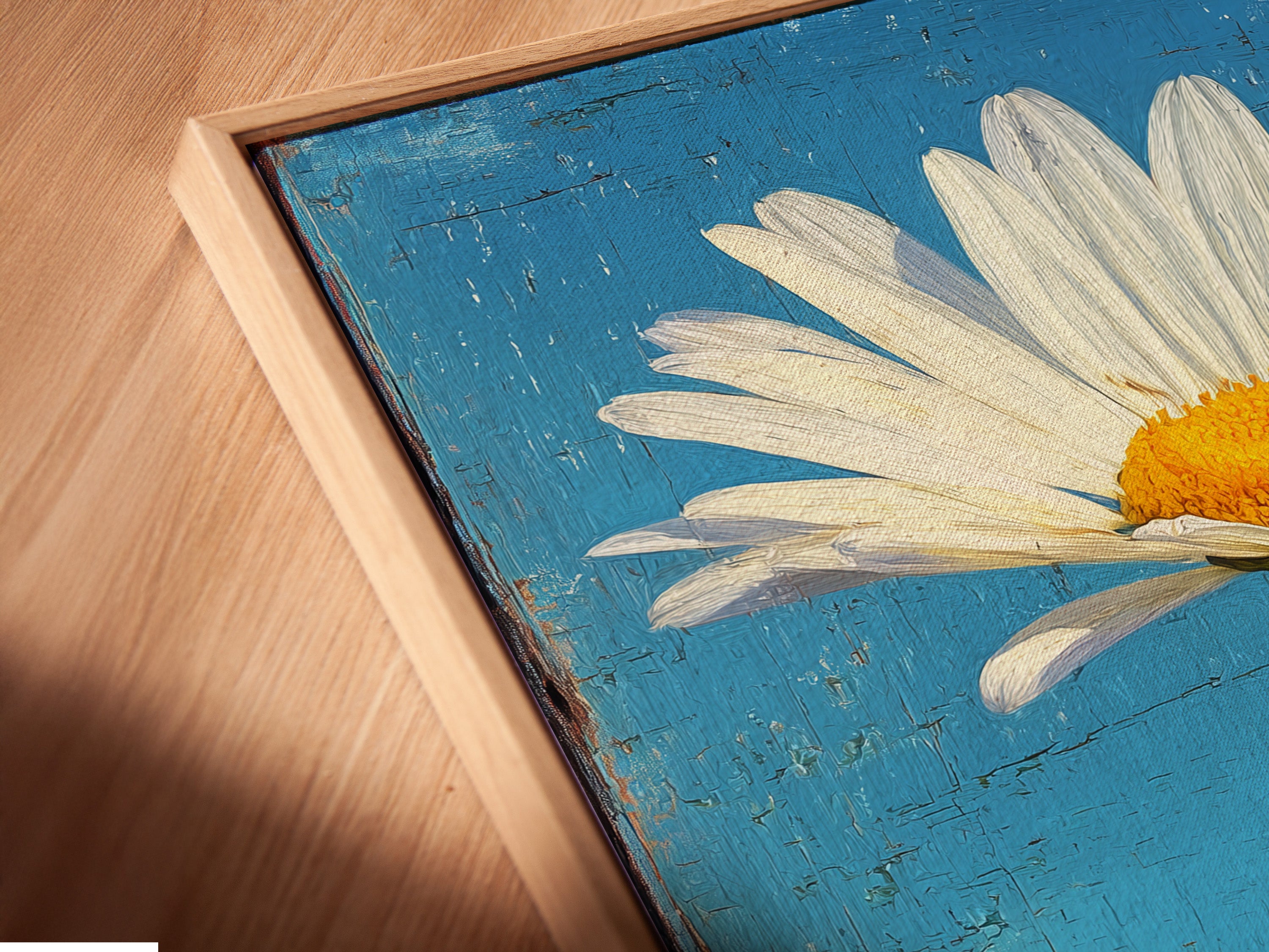 A close-up angled view of a canvas print in a floating frame. The artwork features a daisy flower. The floating frame gives the artwork a modern gallery look. Perfect for showcasing art in a contemporary setting.