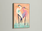 A coastal bird wall art piece featuring herons is displayed in an oak frame. The oak frame enhances the natural beauty of the heron artwork. This frame is perfect for homeowners renters interior designers and business owners seeking elevated modern wall art. This heron art fits coastal minimalist or contemporary styles.