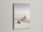 Nautical Wall Decor in a white frame. This serene art piece captures a beautiful seascape. Perfect for adding a touch of the coast to your home. The white frame enhances the minimalist aesthetic.