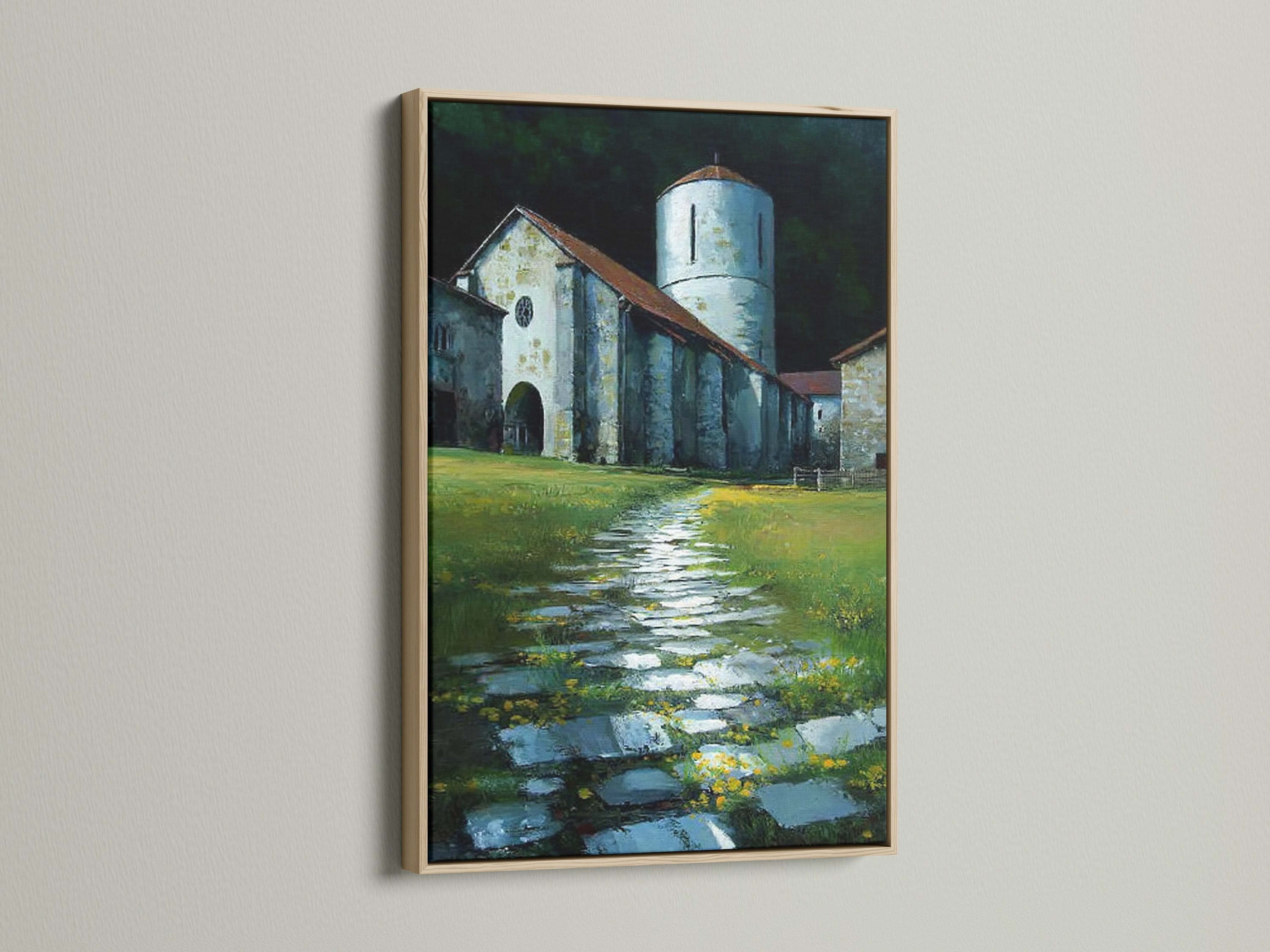 The church tower art is framed in oak. The artwork adds a vintage touch. Perfect wall art for your living room decor. The artwork is displayed on a white wall. The stone path leads to the church