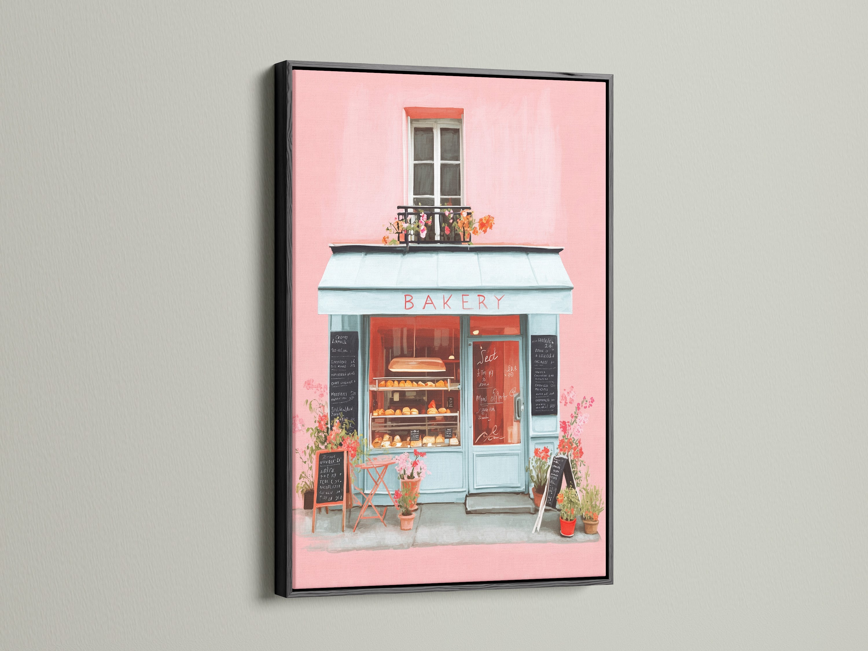 Artwork presented in a black frame. The art captures a bakery storefront with pink walls and a blue awning. The black frame offers a bold and sophisticated contrast. This piece is perfect for adding a stylish statement to your home decor with its striking presence.