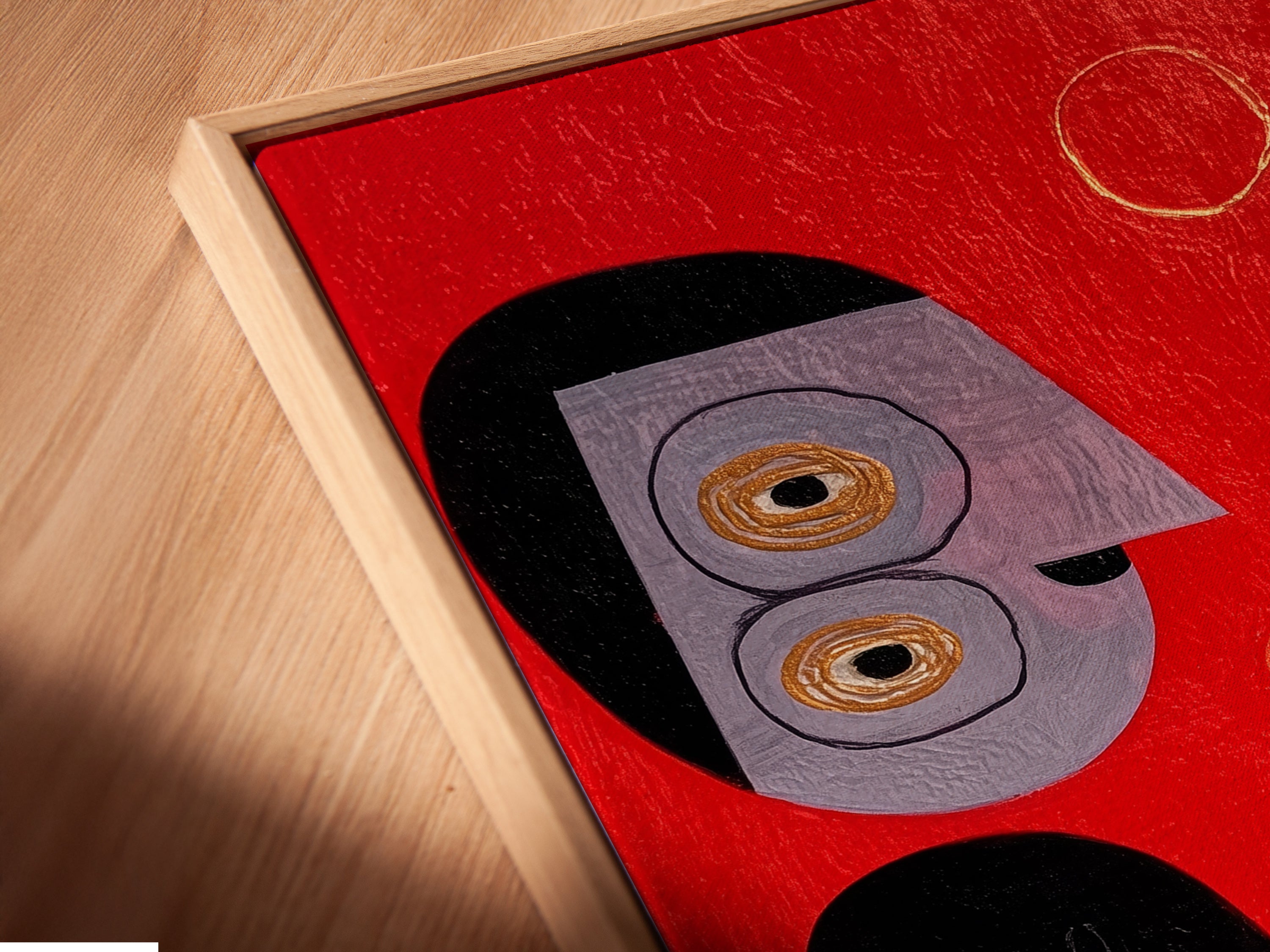 Close-up of a canvas print in a floating frame. The abstract folk artwork features red teal and black colors. This modern art piece adds sophistication to any space. Discover the beauty of our floating frame collection today.