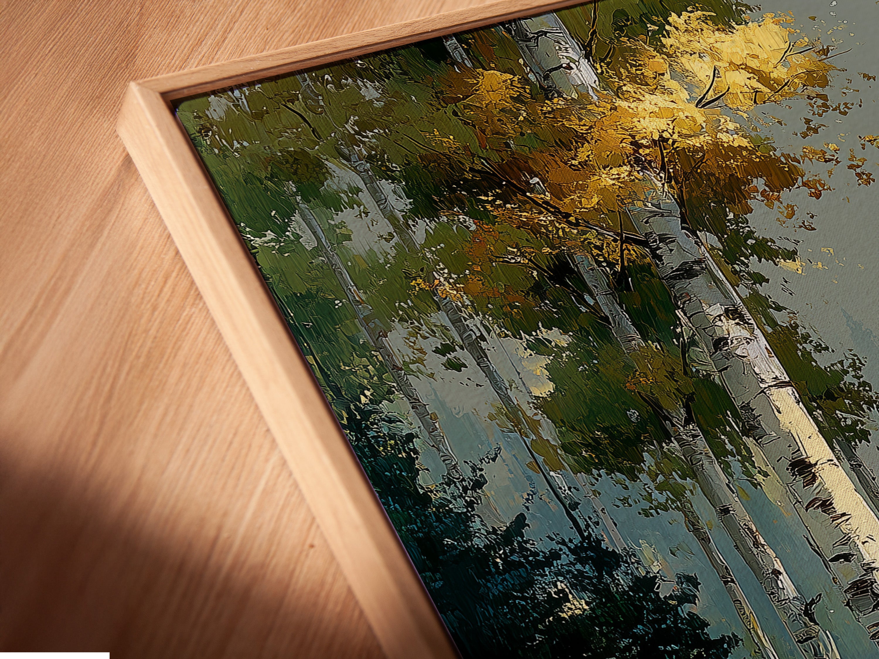 A close up of a Birch Forest canvas print in a floating frame. The autumn landscape is beautifully displayed. The artwork adds a touch of nature to any room. Perfect for adding woodland charm to your decor. The floating frame enhances the overall aesthetic.