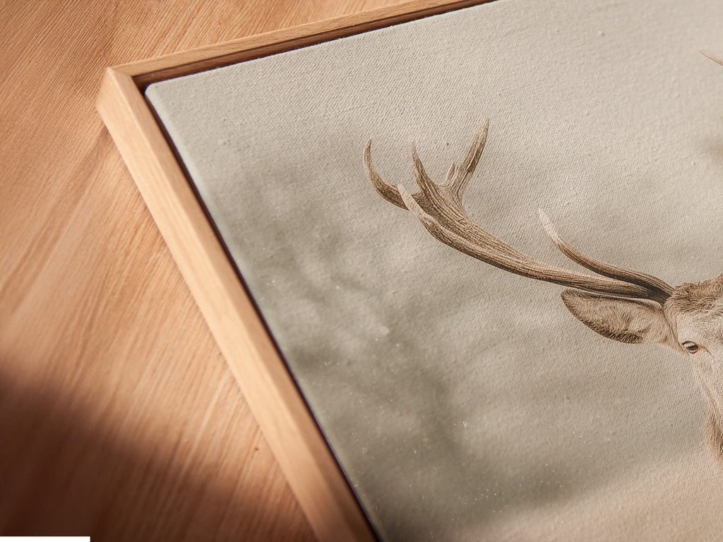 A close up angled view shows a canvas print in a floating frame. The floating frame gives the artwork a modern look. This vintage deer art is ideal for woodland nursery decor. The whimsical animal art is perfect for any room. It adds a touch of rustic charm to your space. Great for country farmhouse or eclectic decor styles.
