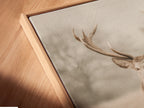 A close up angled view shows a canvas print in a floating frame. The floating frame gives the artwork a modern look. This vintage deer art is ideal for woodland nursery decor. The whimsical animal art is perfect for any room. It adds a touch of rustic charm to your space. Great for country farmhouse or eclectic decor styles.
