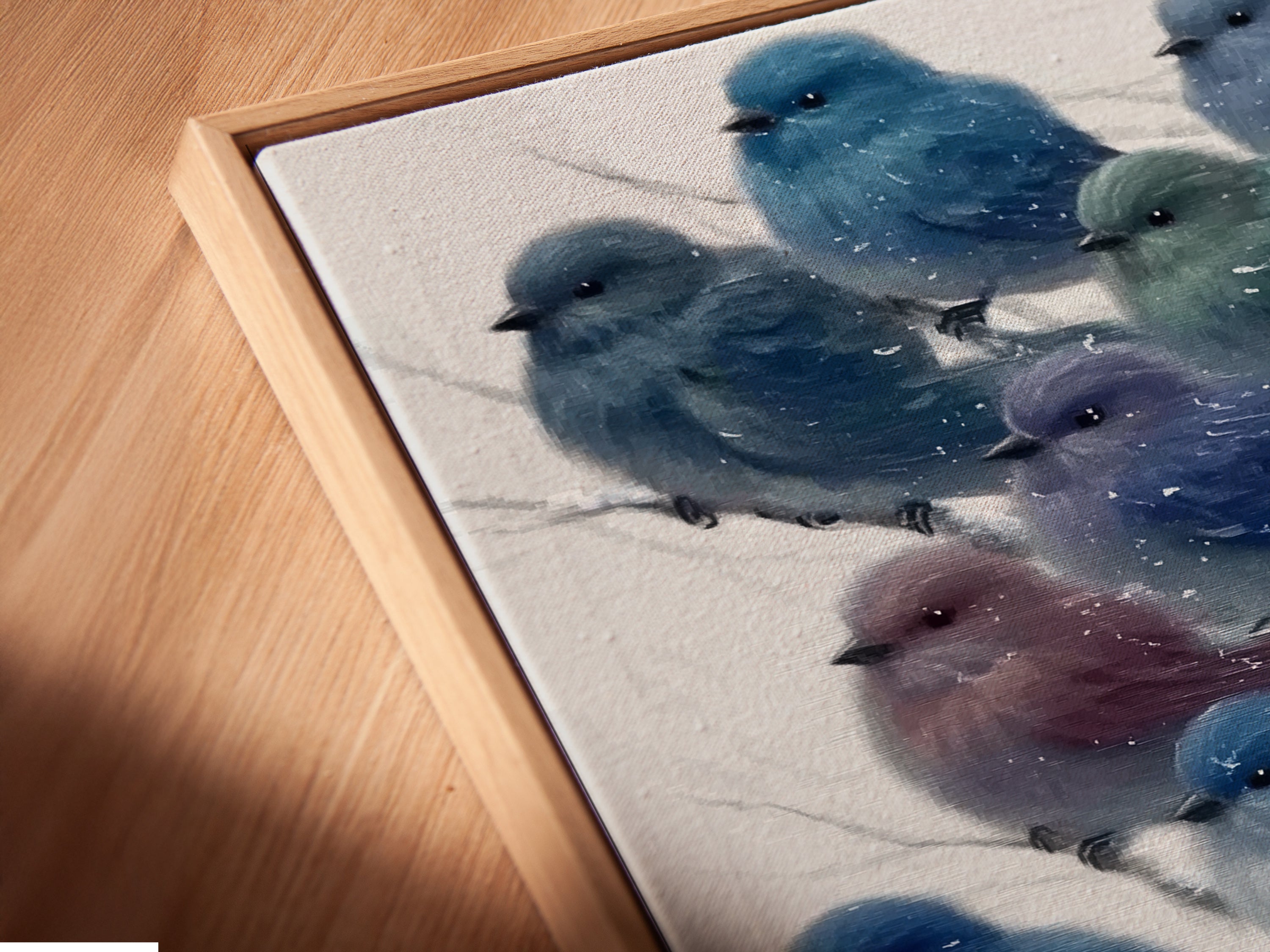 This is a close-up of a canvas print featuring bluebird artwork in a floating frame. The winter bird wall art has a modern aesthetic. The snowy bird artwork enhances any space. A great gift for nature lovers.