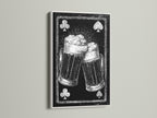 Framed artwork featuring a playing card beer mug art print. The artwork is framed in a white frame. The white frame offers a clean modern look. It will brighten up any room. A perfect gift for a beer lover.