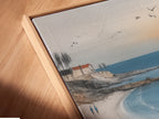A close-up angled view of a canvas print in a floating frame. The coastal wall art is modern and stylish. The beach canvas art seems to float within the frame. Ocean sunset print brings a contemporary touch. Perfect for showcasing seaside landscapes.