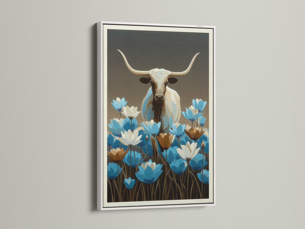 Longhorn bull art with blue wildflowers in a white frame. This is a botanical canvas. Western wall decor is perfect for any room. The bull canvas print is ideal for modern farmhouse decor. A blue floral art piece for your home.