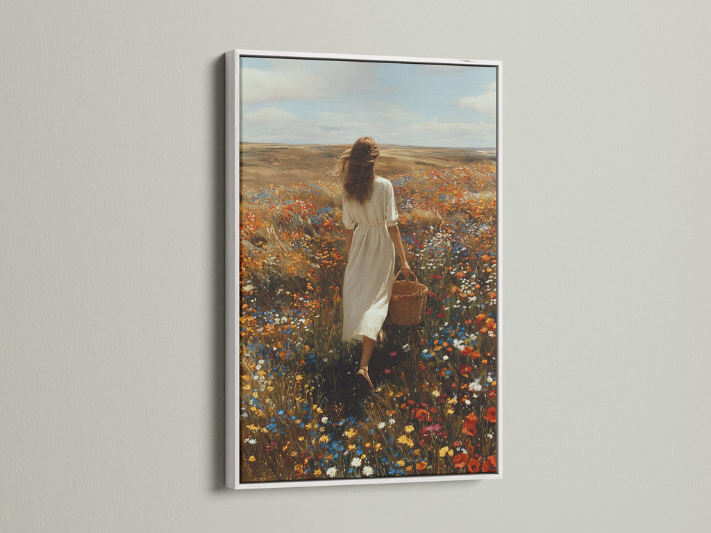 White frame artwork displayed in a modern home. The artwork shows a woman in a white dress. She's walking through a colorful field of flowers. The white frame provides a clean aesthetic. It enhances the artwork's beauty. Explore framed artwork for your home. Elevate your interior with stylish art.