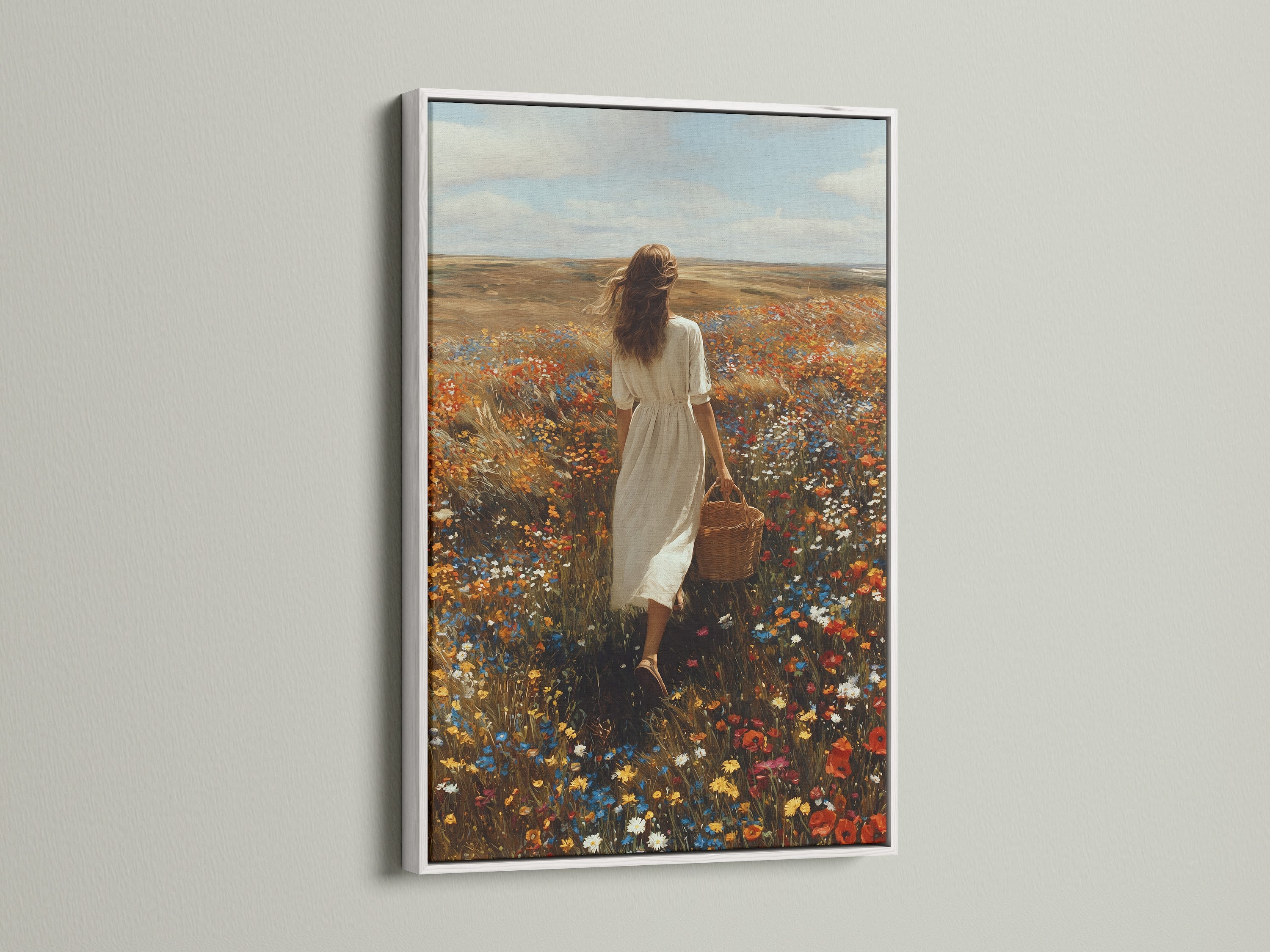 White frame artwork displayed in a modern home. The artwork shows a woman in a white dress. She's walking through a colorful field of flowers. The white frame provides a clean aesthetic. It enhances the artwork's beauty. Explore framed artwork for your home. Elevate your interior with stylish art.