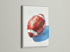 Brighten your walls with this football artwork. This canvas print features a painted style football in a white frame. It brings a contemporary touch to any room. This sports print makes a great addition to a game room or man cave. A stylish sports-themed decor for athletes and fans.
