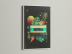 A white frame complements a colorful cassette tape art print. The white frame offers a clean modern look. The artwork features tropical leaves and a sunset. This framed art print is perfect for any space. Add a fresh touch to your home decor.