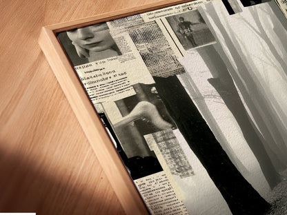 A close up angled view reveals the intricate details of a canvas print within a floating frame. The Foggy Forest Path artwork showcases a black and white collage. The mysterious artwork is perfect for study rooms. This modern wall decor will elevate minimalist and industrial spaces.