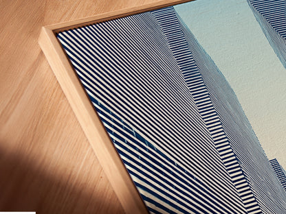 A close-up angled view shows a canvas print in a floating frame. The Cityscape Optical Illusion artwork is modern and eye-catching. The black and white art enhances any room's decor. Perfect for adding an urban and geometric touch to your space.