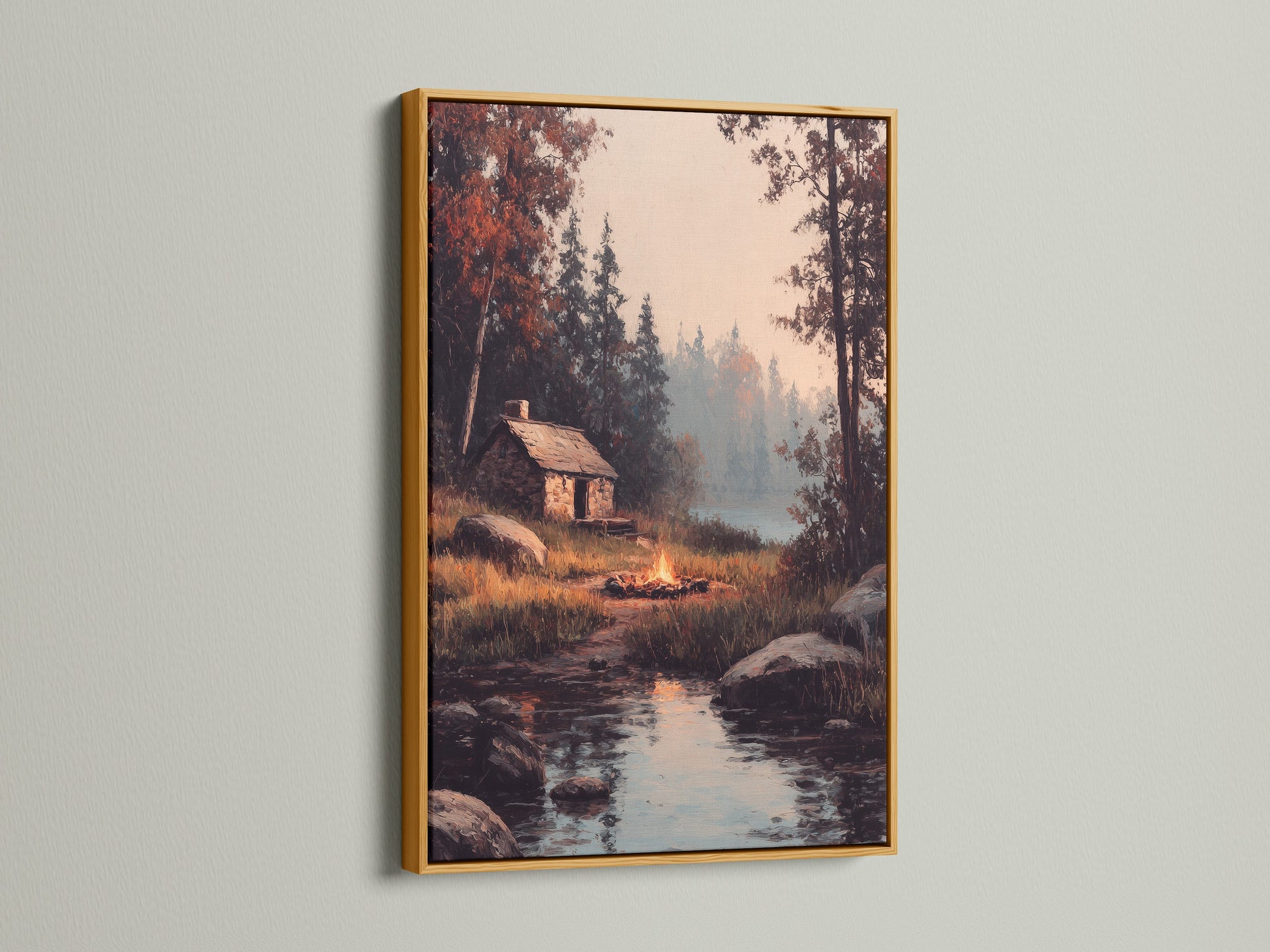 A gold frame highlights artwork of a cabin by a lake. The metallic frame adds a touch of luxury and elegance. Discover the opulence of gold frames. Perfect for making a statement with your art.