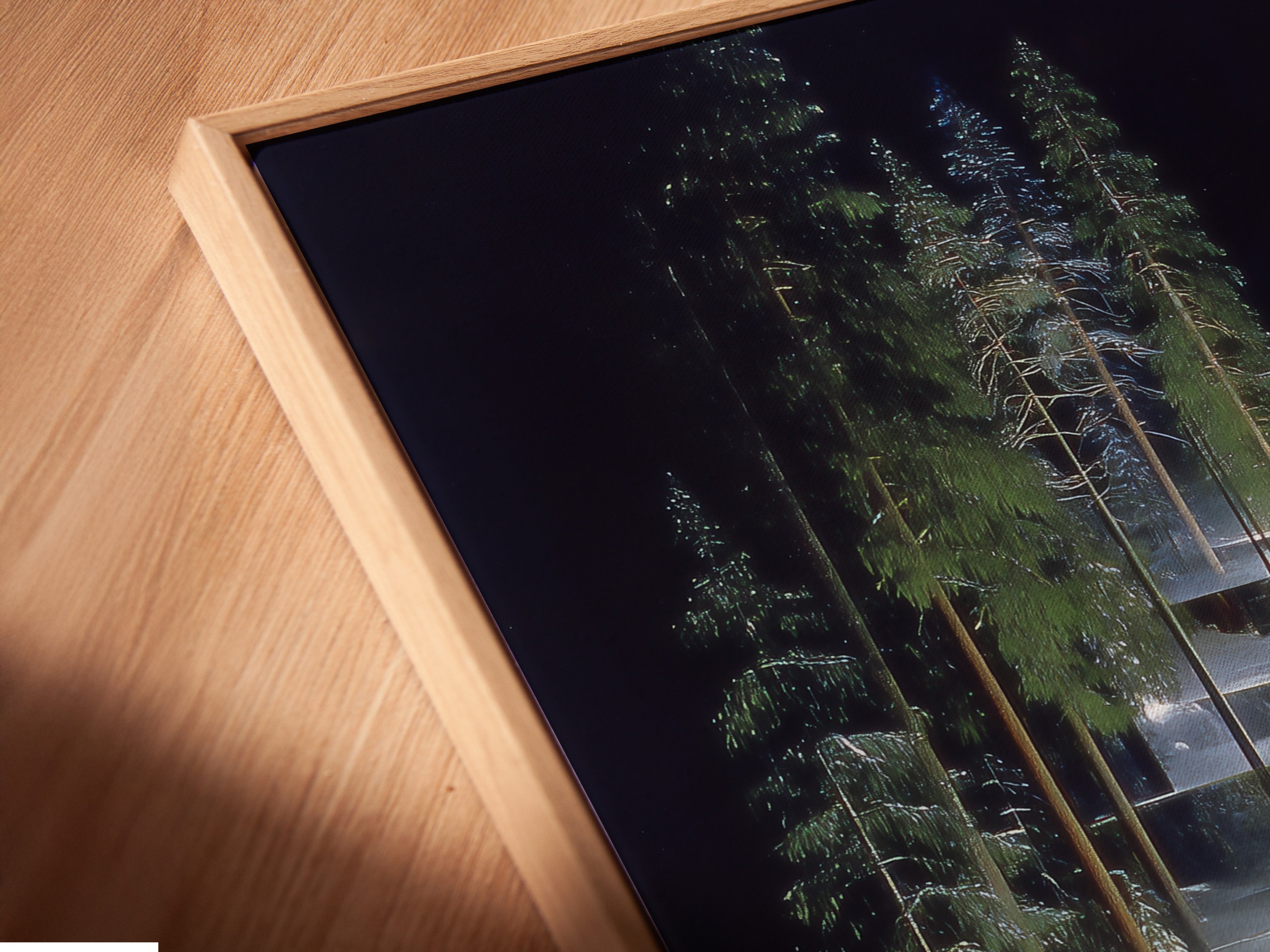 Close up angled view of a canvas print in a floating frame. The modern ski resort artwork enhances any room. The alpine forest wall art brings nature inside. A stylish winter sports print for your home or lodge.